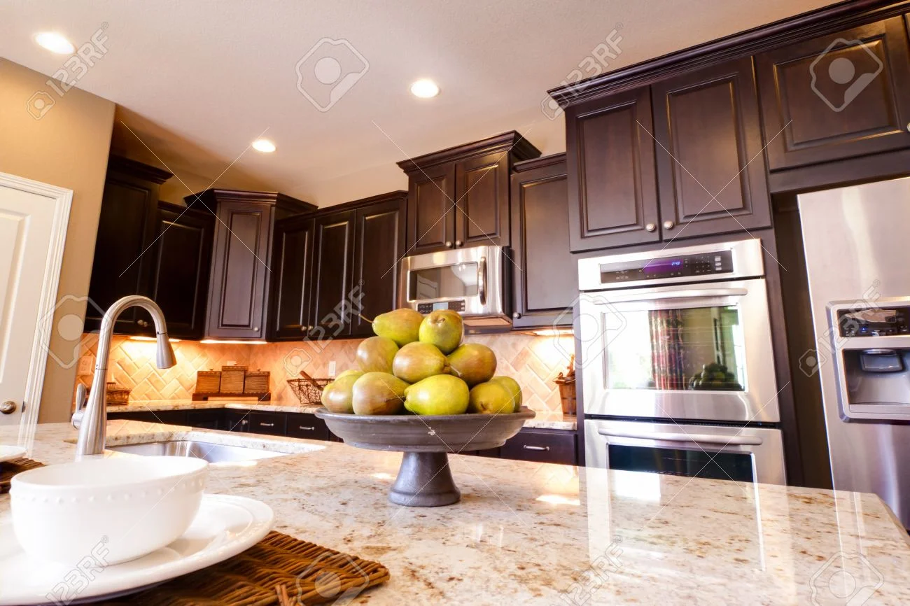Kitchen with wood cabinetry and finished interior surfaces
